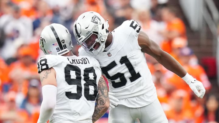 Sep 10, 2023; Denver, Colorado, USA; Las Vegas Raiders defensive end Malcolm Koonce (51) celebrates a sack with defensive end Maxx Crosby (98) against the Denver Broncos in the second quarter at Empower Field at Mile High. Mandatory Credit: Ron Chenoy-USA TODAY Sports