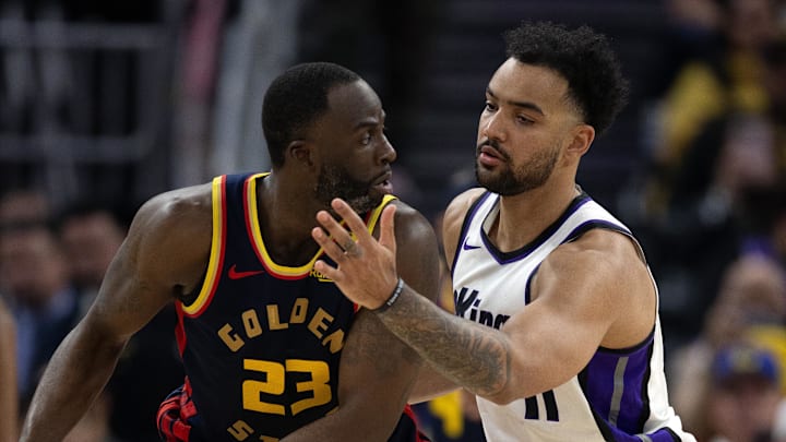 Mar 13, 2025; San Francisco, California, USA; Golden State Warriors forward Draymond Green (23) looks to pass around Sacramento Kings forward Trey Lyles (41) during the second quarter at Chase Center. Mandatory Credit: D. Ross Cameron-Imagn Images