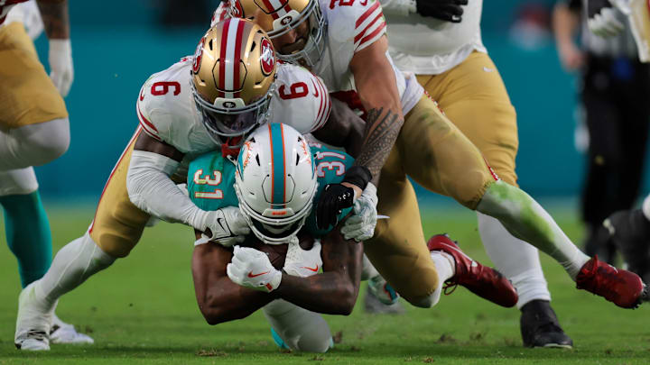 Miami Dolphins running back Raheem Mostert (31) runs with the football against San Francisco 49ers safety Malik Mustapha (6) and safety Talanoa Hufanga (29) during the second quarter at Hard Rock Stadium last December.