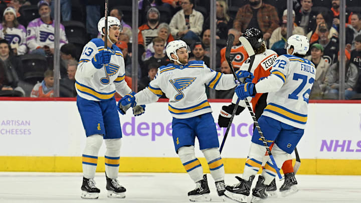 Nov 20, 2025; Philadelphia, Pennsylvania, USA; St. Louis Blues defenseman Justin Faulk (72) celebrates his goal with right wing Alexey Toropchenko (13) and left wing Nathan Walker (26) against the Philadelphia Flyers during the first period at Xfinity Mobile Arena. Mandatory Credit: Eric Hartline-Imagn Images Nov 20, 2025; Philadelphia, Pennsylvania, USA; St. Louis Blues defenseman Justin Faulk (72) celebrates his goal with right wing Alexey Toropchenko (13) and left wing Nathan Walker (26) against the Philadelphia Flyers during the first period at Xfinity Mobile Arena. Mandatory Credit: Eric Hartline-Imagn Images