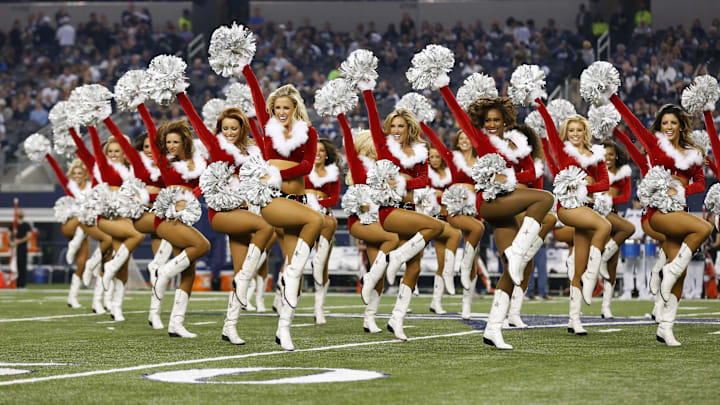 Dallas Cowboys cheerleaders perform for a halftime show for the game in holiday outfits