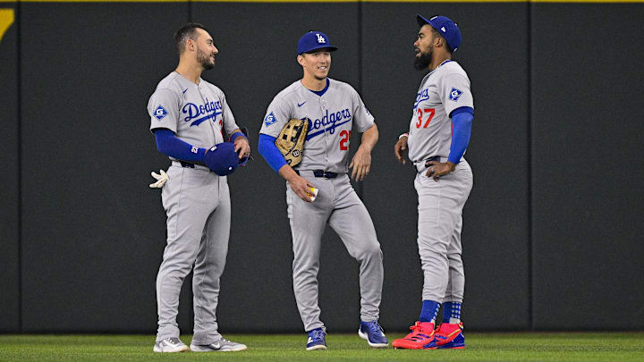 Apr 20, 2025; Arlington, Texas, USA; Los Angeles Dodgers left fielder Michael Conforto (23) and center fielder Tommy Edman (25) and right fielder Teoscar Hernandez (37) during the game between the Texas Rangers and the Los Angeles Dodgers at Globe Life Field. Mandatory Credit: Jerome Miron-Imagn Images