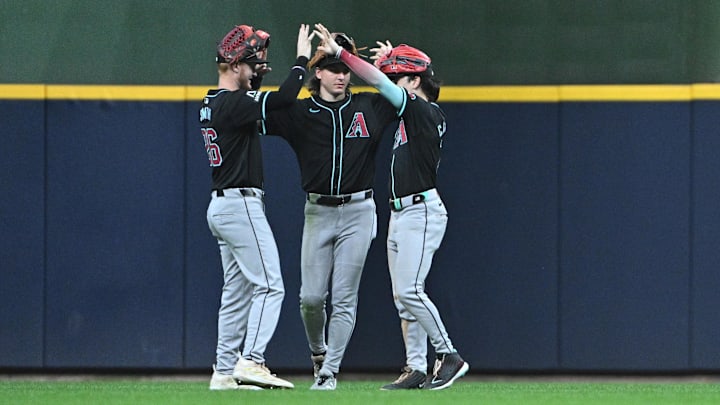Sep 21, 2024; Milwaukee, Wisconsin, USA; Arizona Diamondbacks outfielder Randal Grichuk (15), Arizona Diamondbacks outfielder Jake McCarthy (31) and Arizona Diamondbacks outfielder Corbin Carroll (7) celebrate a win over the Milwaukee Brewers at American Family Field. Mandatory Credit: Michael McLoone-Imagn Images
