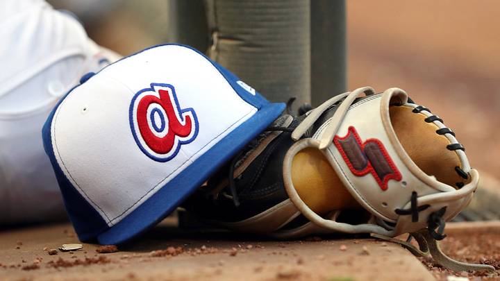 Aug 2, 2019; Atlanta, GA, USA; An Atlanta Braves throw back hat is shown with a glove in the dugout during the fifth inning against Cincinnati Reds at SunTrust Park. Mandatory Credit: Jason Getz-USA TODAY Sports Aug 2, 2019; Atlanta, GA, USA; An Atlanta Braves throw back hat is shown with a glove in the dugout during the fifth inning against Cincinnati Reds at SunTrust Park. Mandatory Credit: Jason Getz-USA TODAY Sports