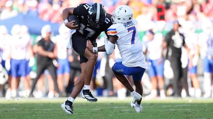 South Florida quarterback Byrum Brown runs over Boise State defensive back A'Marion McCoy.