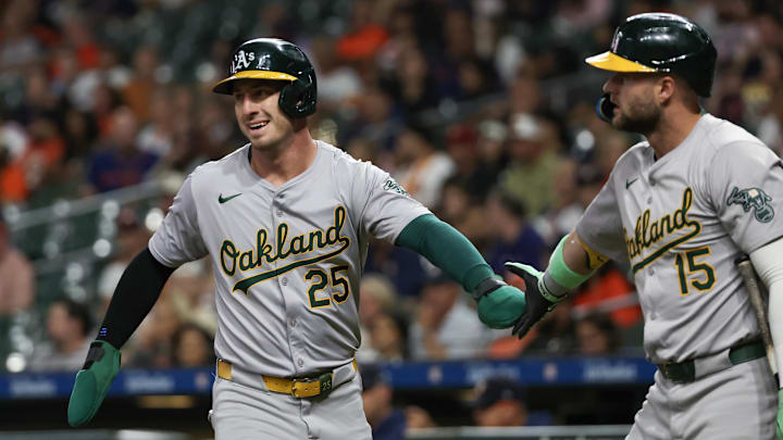 Sep 10, 2024; Houston, Texas, USA; Oakland Athletics right fielder Seth Brown (15) celebrates designated hitter Brent Rooker (25) run against the Houston Astros  in the first inning at Minute Maid Park. Mandatory Credit: Thomas Shea-Imagn Images