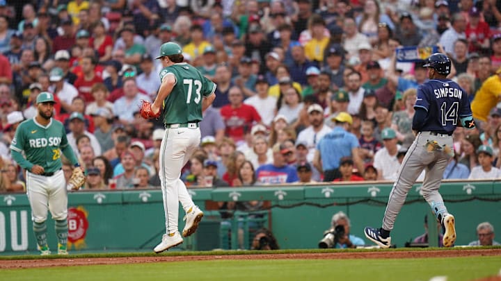 Boston, Massachusetts, USA; Boston Red Sox pitcher Hunter Dobbins (73) is hurt after a play at first against Tampa Bay Rays outfielder Chandler Simpson (14) in the second inning at Fenway Park.