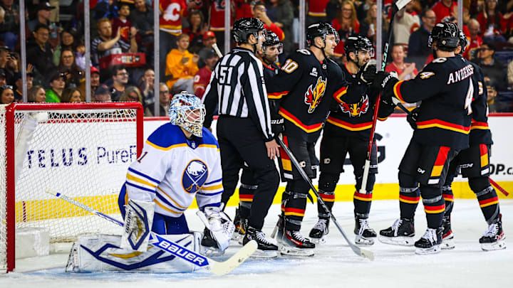 Dec 8, 2025; Calgary, Alberta, CAN; Calgary Flames left wing Jonathan Huberdeau (10) scores a goal against Buffalo Sabres goaltender Ukko-Pekka Luukkonen (1) during the second period at Scotiabank Saddledome. Mandatory Credit: Sergei Belski-Imagn Images