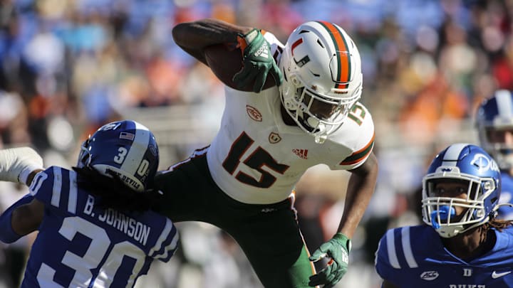 Nov 27, 2021; Durham, North Carolina, USA; Miami Hurricanes wide receiver Jacolby George (15) with the ball jumps but is taken down by Duke Blue Devils safety Brandon Johnson (30) during the first half of the game against the Miami Hurricanes at Wallace Wade Stadium. at Wallace Wade Stadium. Mandatory Credit: Jaylynn Nash-Imagn Images