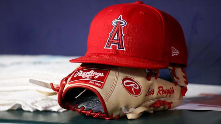 A detailed view of a Los Angeles Angels hat and glove on the bench against the Atlanta Braves in the eighth inning at Truist Park on Aug. 1, 2023.
