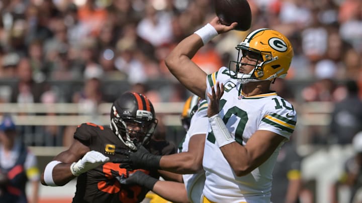 Sep 21, 2025; Cleveland, Ohio, USA; Green Bay Packers quarterback Jordan Love (10) throws a pass as Cleveland Browns defensive end Myles Garrett (95) rushes during the first quarter at Huntington Bank Field. Mandatory Credit: Ken Blaze-Imagn Images