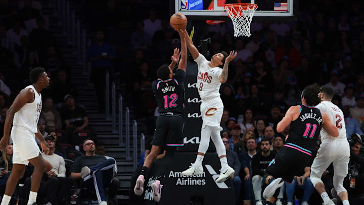 Nov 12, 2025; Miami, Florida, USA; Cleveland Cavaliers guard Craig Porter Jr. (9) block a shot against Miami Heat guard Dru Smith (12) during the second quarter at Kaseya Center. Mandatory Credit: Sam Navarro-Imagn Images