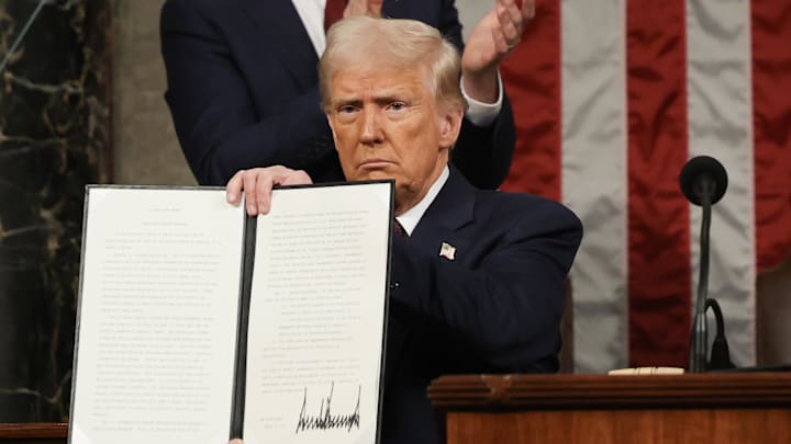 Mar 4, 2025; Washington, DC, USA; U.S. President Donald Trump holds a copy of an executive order honoring Jocelyn Nungaray, a a 12-year-old girl who was killed by illegal immigrants, as he addresses a joint session of Congress at the U.S. Capitol on March 04, 2025 in Washington, DC. President Trump was expected to address Congress on his early achievements of his presidency and his upcoming legislative agenda. Mandatory Credit: Win McNamee-Pool via Imagn Images