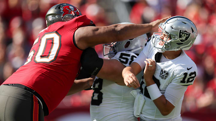 Dec 8, 2024; Tampa, Florida, USA; Las Vegas Raiders quarterback Aidan O'Connell (12) is pressured by Tampa Bay Buccaneers defensive tackle Vita Vea (50) in the first quarter at Raymond James Stadium. Mandatory Credit: Nathan Ray Seebeck-Imagn Images