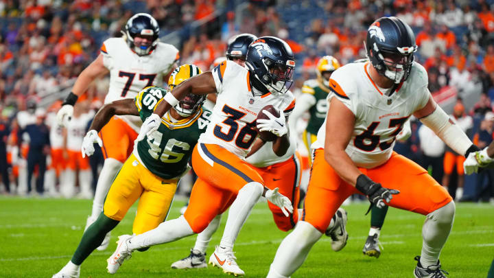 Aug 18, 2024; Denver, Colorado, USA; Denver Broncos running back Tyler Badie (36) runs for a touchdown in the fourth quarter against the Green Bay Packers  at Empower Field at Mile High. Mandatory Credit: Ron Chenoy-USA TODAY Sports