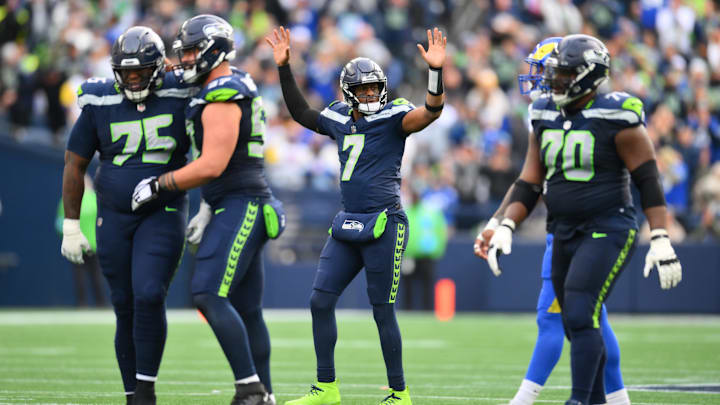 Nov 3, 2024; Seattle, Washington, USA; Seattle Seahawks quarterback Geno Smith (7) celebrates after throwing a touchdown pass against the Los Angeles Rams during the first half at Lumen Field. Mandatory Credit: Steven Bisig-Imagn Images