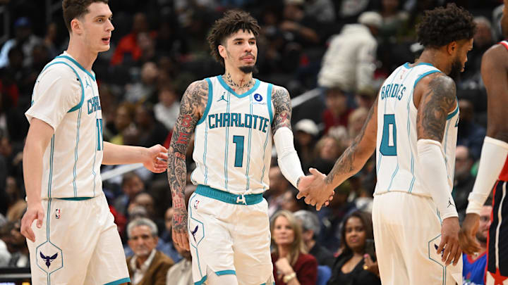 Oct 26, 2025; Washington, District of Columbia, USA; Charlotte Hornets guard LaMelo Ball (1) celebrates with center Ryan Kalkbrenner (11) and forward Miles Bridges (0) against the Washington Wizards during the fourth quarter at Capital One Arena. Mandatory Credit: Rafael Suanes-Imagn Images Oct 26, 2025; Washington, District of Columbia, USA; Charlotte Hornets guard LaMelo Ball (1) celebrates with center Ryan Kalkbrenner (11) and forward Miles Bridges (0) against the Washington Wizards during the fourth quarter at Capital One Arena. Mandatory Credit: Rafael Suanes-Imagn Images