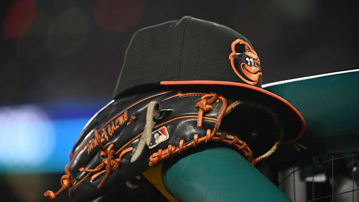 May 8, 2024; Washington, District of Columbia, USA; A Baltimore Orioles hat and glove rest on the dugout rail during a game against the Washington Nationals at Nationals Park.