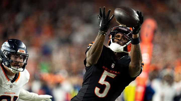 Cincinnati Bengals wide receiver Tee Higgins (5) catches a pass inside the 5-yard line as Denver Broncos cornerback Riley Moss (21) defends in overtime of the NFL game at Paycor Stadium in Cincinnati on Saturday, Dec. 28, 2024.