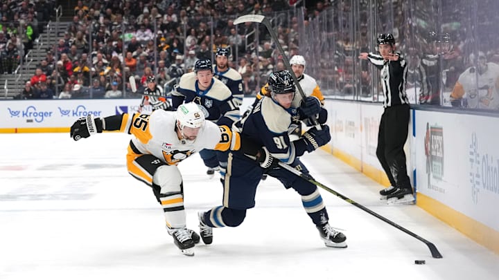 Blue Jackets forward Kent Johnson tries to beat Penguins defenseman Kent Johnson. Blue Jackets forward Kent Johnson tries to beat Penguins defenseman Kent Johnson.