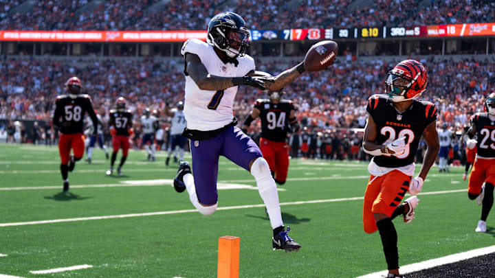 Baltimore Ravens wide receiver Rashod Bateman (7) scores a touchdown as Cincinnati Bengals cornerback Josh Newton (28) attempts to stop him in the first quarter of the NFL game at Paycor Stadium in Cincinnati on Sunday, Oct. 6, 2024.