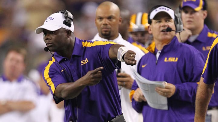 Sep 3, 2011; Arlington, TX, USA; LSU Tigers running backs coach Frank Wilson (left) signals from the sidelines with head coach Les Miles against the Oregon Ducks at Cowboys Stadium. Mandatory Credit: Matthew Emmons-Imagn Images