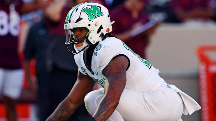 Sep 7, 2024; Blacksburg, Virginia, USA; Marshall Thundering Herd defensive lineman Mike Green (15) celebrates after sacking Virginia Tech Hokies quarterback Kyron Drones (1) during the first quarter at Lane Stadium. Mandatory Credit: Peter Casey-Imagn Images