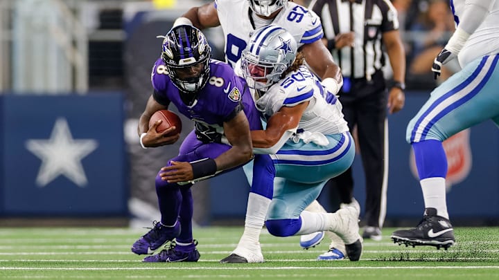 Baltimore Ravens quarterback Lamar Jackson is tackled by Dallas Cowboys linebacker Eric Kendricks.