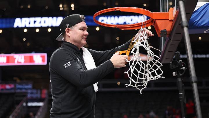 Mar 14, 2026; Kansas City, MO, USA; Arizona Wildcats head coach Tommy Lloyd cuts the net after a win over the Houston Cougars during the men's Big 12 Conference Tournament Championship at T-Mobile Center. Mar 14, 2026; Kansas City, MO, USA; Arizona Wildcats head coach Tommy Lloyd cuts the net after a win over the Houston Cougars during the men's Big 12 Conference Tournament Championship at T-Mobile Center.