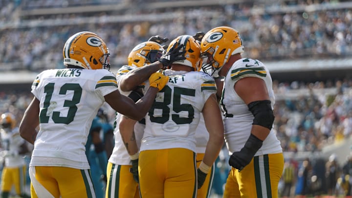 Oct 27, 2024; Jacksonville, Florida, USA; Green Bay Packers tight end Tucker Kraft (85), center Josh Myers (71), and wide receiver Dontayvion Wicks (13) celebrate a touchdown against the Jacksonville Jaguars during the fourth quarter at EverBank Stadium. Mandatory Credit: Morgan Tencza-Imagn Images