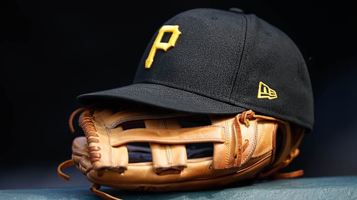Jun 30, 2021; Denver, Colorado, USA; A general view of a Pittsburgh Pirates glove and hat in the eighth inning against the Colorado Rockies at Coors Field.