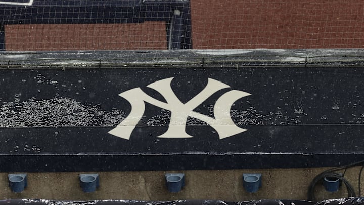 Aug 17, 2020; Bronx, New York, USA; A general view of rain falling on the  New York Yankees logo on the first base dugout roof during a rain delay in the game between the New York Yankees and the Boston Red Sox. Mandatory Credit: Vincent Carchietta-Imagn Images