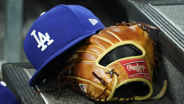 Apr 28, 2024; Toronto, Ontario, CAN; A hat and glove of an Los Angeles Dodgers player durng a game against the Toronto Blue Jays at Rogers Centre. Mandatory Credit: John E. Sokolowski-Imagn Images Apr 28, 2024; Toronto, Ontario, CAN; A hat and glove of an Los Angeles Dodgers player durng a game against the Toronto Blue Jays at Rogers Centre. Mandatory Credit: John E. Sokolowski-Imagn Images