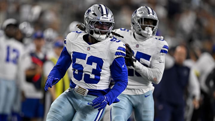 Dallas Cowboys linebacker James Houston and cornerback Andrew Booth return an interception for a touchdown.