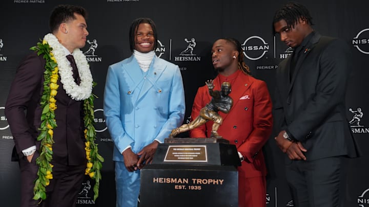 The four Heisman Trophy finalists stand next to the trophy in New York City.