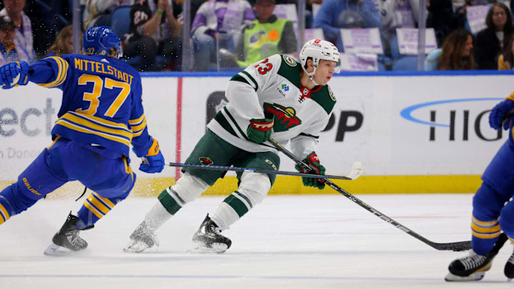 Nov 10, 2023; Buffalo, New York, USA;  Minnesota Wild center Marco Rossi (23) looks to make a pass as Buffalo Sabres center Casey Mittelstadt (37) defends during the first period at KeyBank Center. Mandatory Credit: Timothy T. Ludwig-USA TODAY Sports
