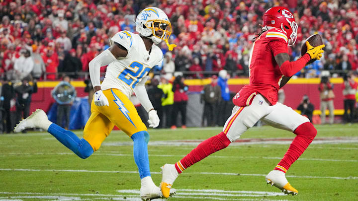 Dec 8, 2024; Kansas City, Missouri, USA; Kansas City Chiefs wide receiver Xavier Worthy (1) runs the ball as Los Angeles Chargers cornerback Cam Hart (20) defends during the first half at GEHA Field at Arrowhead Stadium. Mandatory Credit: Denny Medley-Imagn Images
