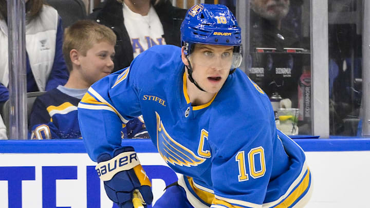 Mar 1, 2025; St. Louis, Missouri, USA;  St. Louis Blues center Brayden Schenn (10) controls the puck against the Los Angeles Kings during the second period at Enterprise Center. Mandatory Credit: Jeff Curry-Imagn Images