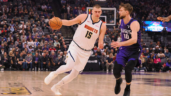 Feb 9, 2024; Sacramento, California, USA; Denver Nuggets center Nikola Jokic (15) drives in against Sacramento Kings center Domantas Sabonis (10) during the first quarter at Golden 1 Center. Mandatory Credit: Kelley L Cox-Imagn Images