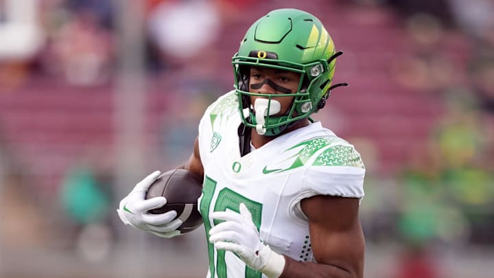 Sep 30, 2023; Stanford, California, USA; Oregon Ducks tight end Kenyon Sadiq (18) carries the ball against the Stanford Cardinal during the second quarter at Stanford Stadium. Mandatory Credit: Darren Yamashita-Imagn Images