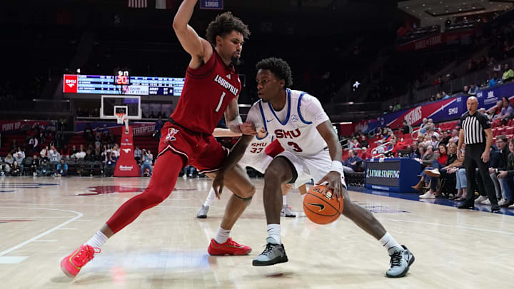 Jan 21, 2025; Dallas, Texas, USA; SMU Mustangs guard Chuck Harris (3) dribbles against the defense of Louisville Cardinals guard J'Vonne Hadley (1) during the second half at Moody Coliseum. Mandatory Credit: Raymond Carlin III-Imagn Images