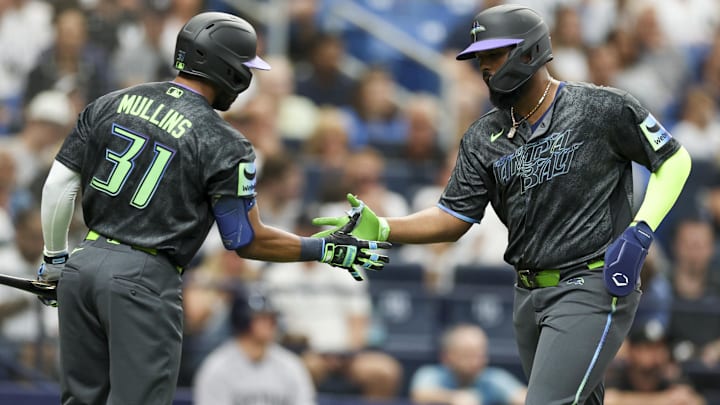 Apr 11, 2026; St. Petersburg, Florida, USA; Tampa Bay Rays center fielder Cedric Mullins (31) greets third baseman Junior Caminero (13) after scoring a run against the New York Yankees in the second inning at Tropicana Field.