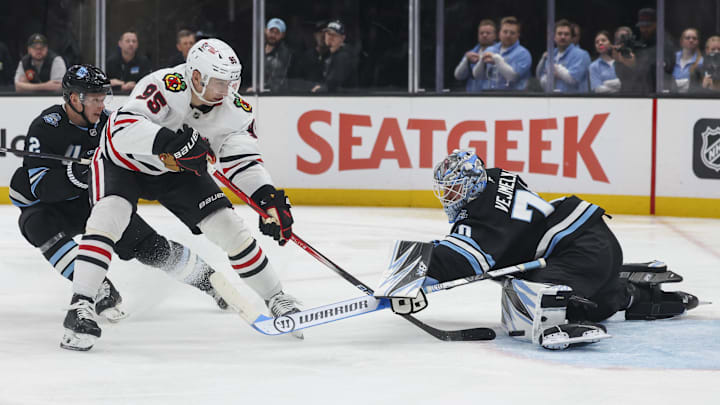 Feb 25, 2025; Salt Lake City, Utah, USA; Utah Hockey Club goaltender Karel Vejmelka (70) blocks the shot of Chicago Blackhawks right wing Ilya Mikheyev (95) during the second period at Delta Center. Mandatory Credit: Rob Gray-Imagn Images