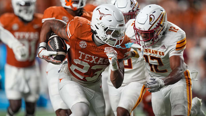 Sep 21, 2024; Austin, Texas, USA;  Texas Longhorns running back Jaydon Blue (23) runs in front of Louisiana Monroe Warhawks defensive back Wydett Williams Jr. (12) in the second half at Darrell K Royal-Texas Memorial Stadium. Mandatory Credit: Daniel Dunn-Imagn Images