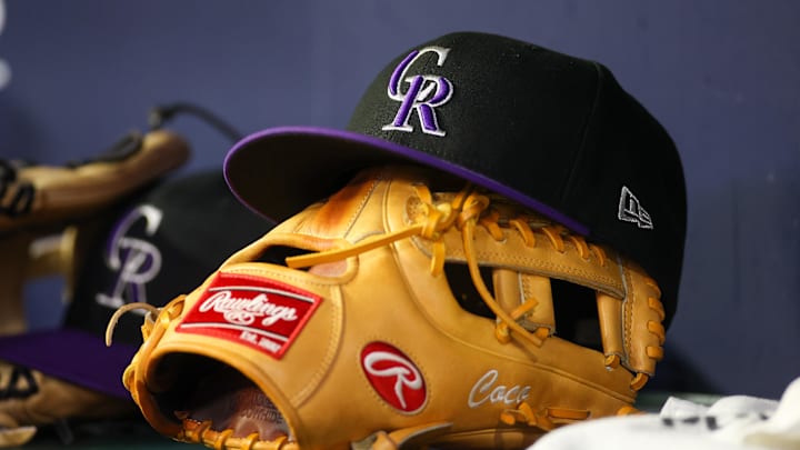 Jun 15, 2023; Atlanta, Georgia, USA; A detailed view of a Colorado Rockies hat and glove on the bench against the Atlanta Braves in the ninth inning at Truist Park. 