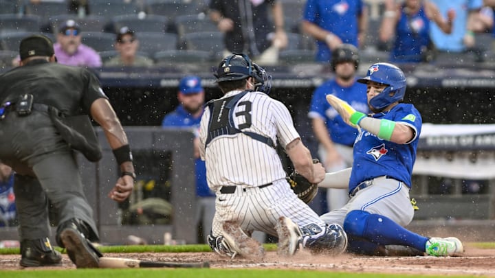 Sep 6, 2025; Bronx, New York, USA; New York Yankees catcher Austin Wells (28) tags out Toronto Blue Jays shortstop Bo Bichette (11) at home plate during the sixth inning at Yankee Stadium. Mandatory Credit: John Jones-Imagn Images