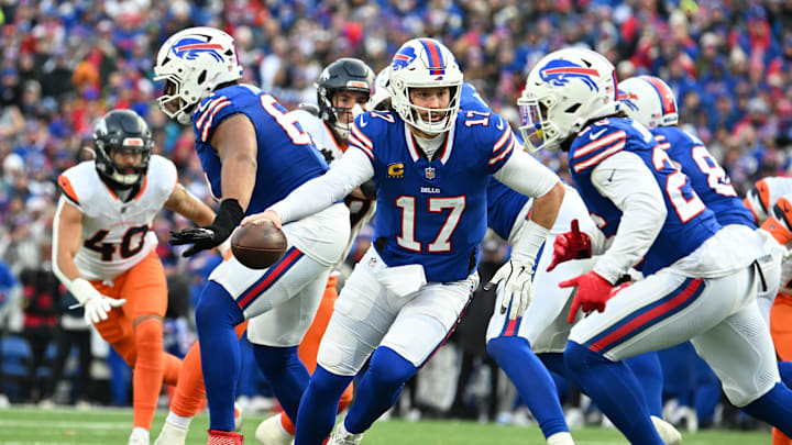 Jan 12, 2025; Orchard Park, New York, USA; Buffalo Bills quarterback Josh Allen (17) hands the ball off to running back Ty Johnson (26) 