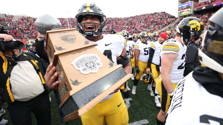 Nov 24, 2023; Lincoln, Nebraska, USA; Iowa Hawkeyes defensive lineman Yahya Black (94) carries the Heroes Trophy after beating the Nebraska Cornhuskers at Memorial Stadium. Mandatory Credit: Reese Strickland-USA TODAY Sports Nov 24, 2023; Lincoln, Nebraska, USA; Iowa Hawkeyes defensive lineman Yahya Black (94) carries the Heroes Trophy after beating the Nebraska Cornhuskers at Memorial Stadium. Mandatory Credit: Reese Strickland-USA TODAY Sports