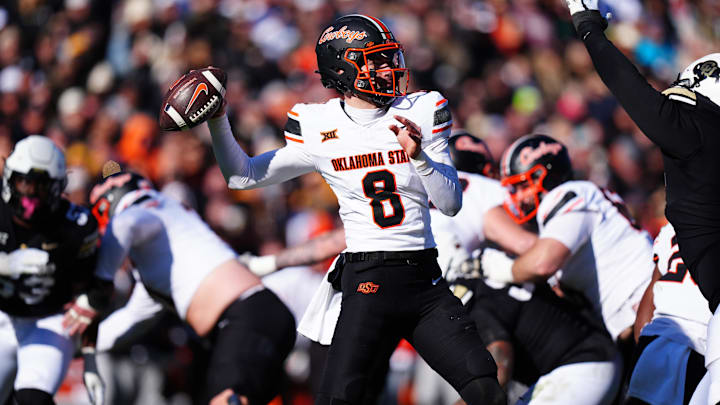 Nov 29, 2024; Boulder, Colorado, USA; Oklahoma State Cowboys quarterback Maealiuaki Smith (8 prepares to pass the ball in the second quarter against the Colorado Buffaloes at Folsom Field. Mandatory Credit: Ron Chenoy-Imagn Images