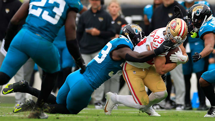 San Francisco 49ers running back Christian McCaffrey (23) is dragged down by his facemark by Jacksonville Jaguars linebacker Devin Lloyd (33) during the second quarter of an NFL football game Sunday, Nov. 12, 2023 at EverBank Stadium in Jacksonville, Fla. The San Francisco 49ers defeated the Jacksonville Jaguars 34-3. [Corey Perrine/Florida Times-Union]